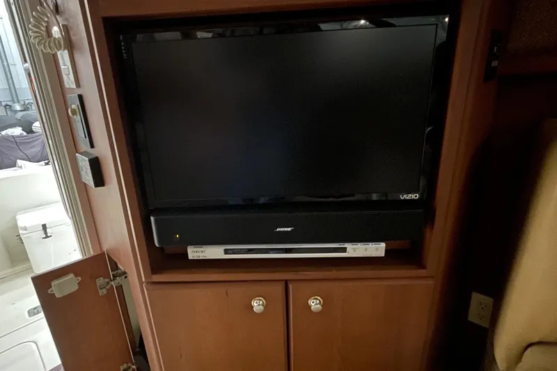 Slide: The Image of Entertainment system with Vizio TV and Bose soundbar on 2005 Silverton 34 Convertible. - 29