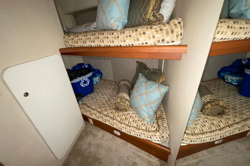 Slide: The Image of 2005 Silverton 34 Convertible interior with cozy bunk beds and decorative pillows. - 32