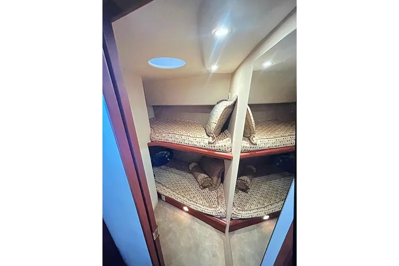 Slide: The Image of 2005 Silverton 34 Convertible cabin with cozy bunk beds and ambient lighting. - 33