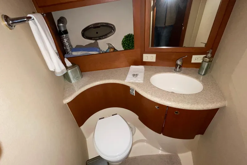Slide: The Image of 2005 Silverton 34 Convertible bathroom with modern sink, toilet, and wooden cabinetry. - 36