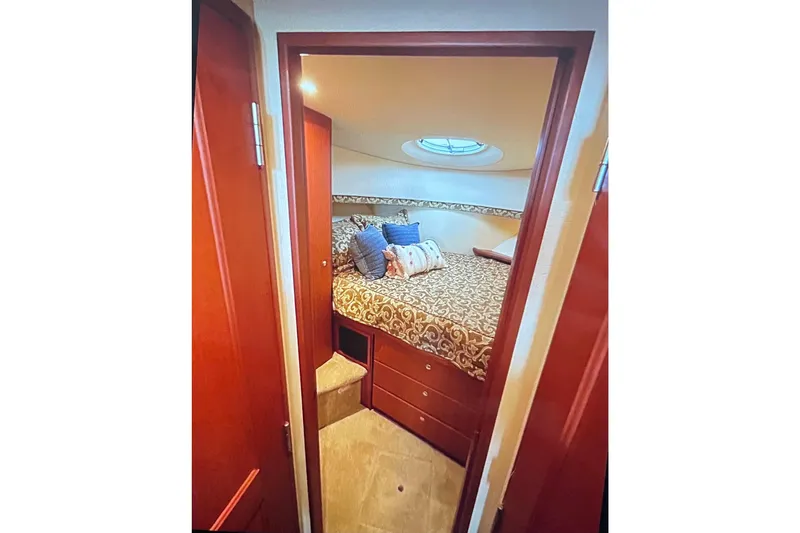 Slide: The Image of 2005 Silverton 34 Convertible cabin interior with bed and decorative pillows. - 41