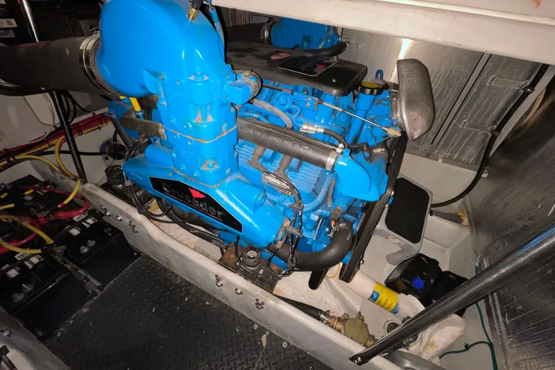 Slide: The Image of Engine compartment of a 2005 Silverton 34 Convertible boat with blue engine components. - 44