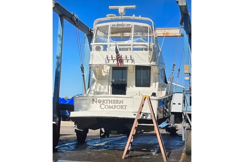 Slide: The Image of 2005 Silverton 34 Convertible yacht, "Northern Comfort," in dry dock with blue sky background. - 45