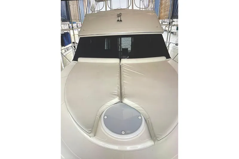 Slide: The Image of 2005 Silverton 34 Convertible yacht with cushioned deck and cabin windows. - 46