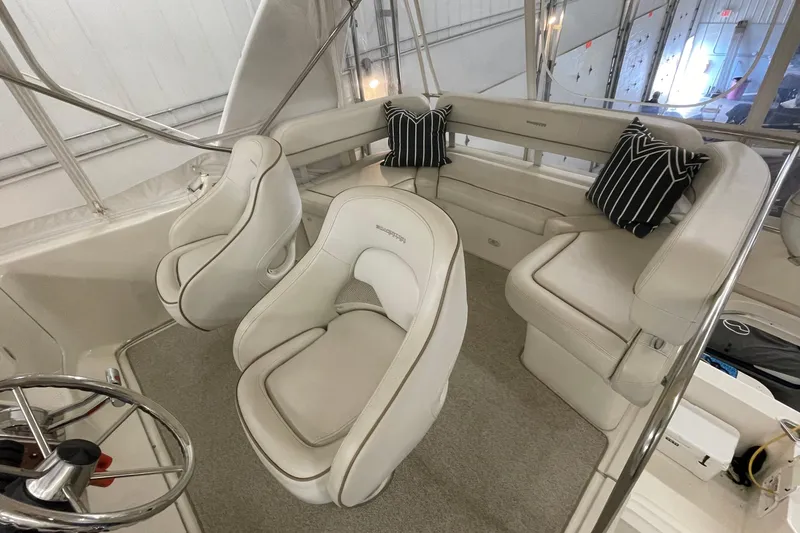 Slide: The Image of 2005 Silverton 34 Convertible yacht interior with plush seating and striped cushions. - 6