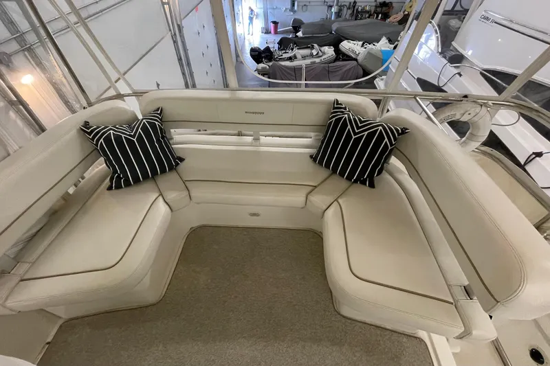 Slide: The Image of 2005 Silverton 34 Convertible yacht interior with cushioned seating and striped pillows. - 8