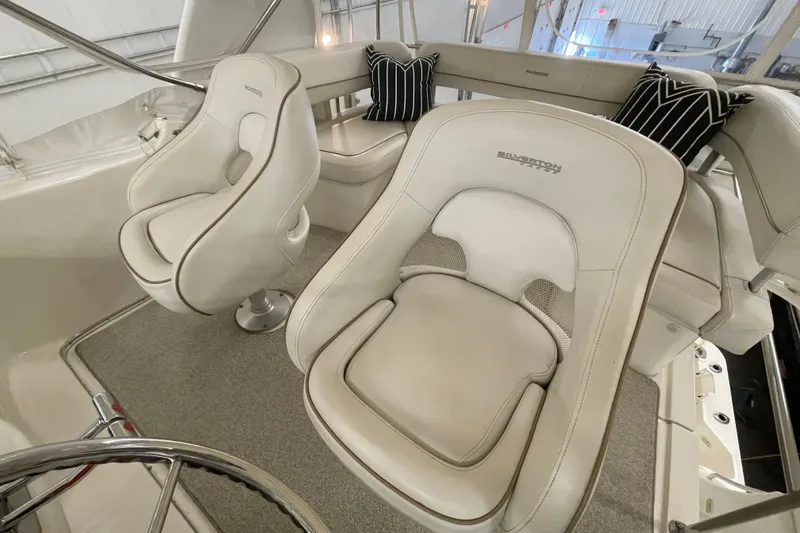Slide: The Image of 2005 Silverton 34 Convertible boat interior with plush white seating and stylish cushions. - 9