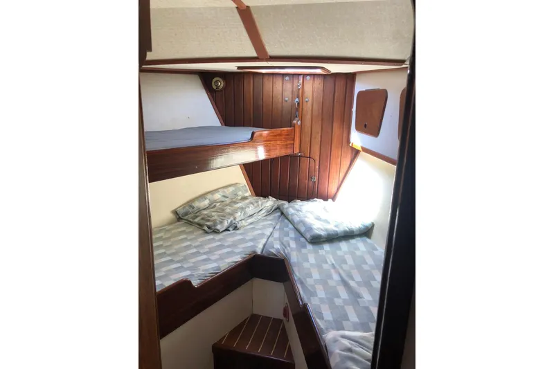 Slide: The Image of Interior cabin of 1990 Bruce Roberts Mauritius Ketch with wooden paneling and bunk beds. - 12