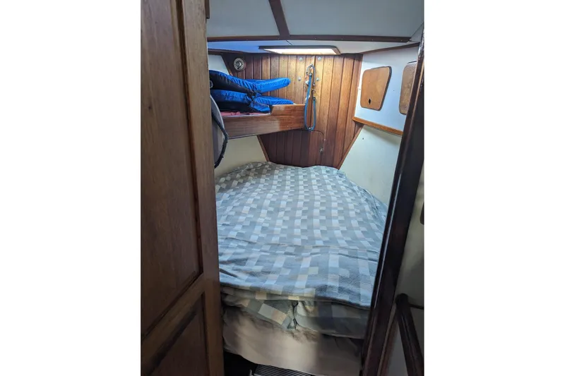 Slide: The Image of Cozy cabin interior of 1990 Bruce Roberts Mauritius Ketch sailboat with wooden paneling. - 13