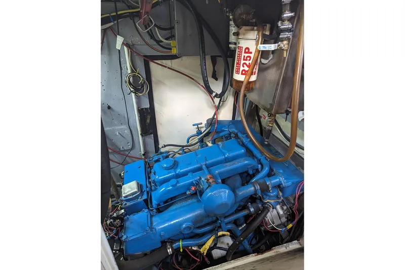 Slide: The Image of Engine compartment of a 1990 Bruce Roberts Mauritius Ketch with blue engine and wiring. - 18