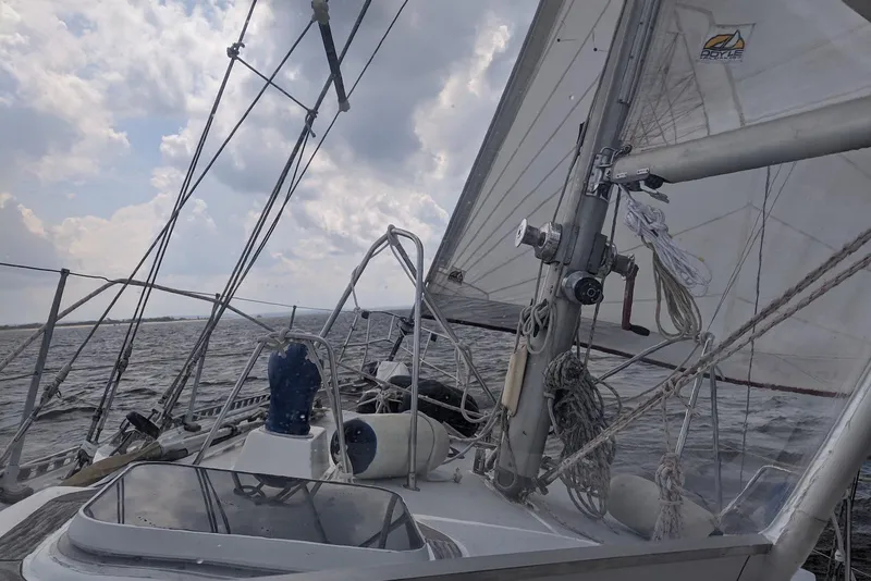 Slide: The Image of Sailing on a 1990 Bruce Roberts Mauritius Ketch with vibrant red and yellow sails. - 2