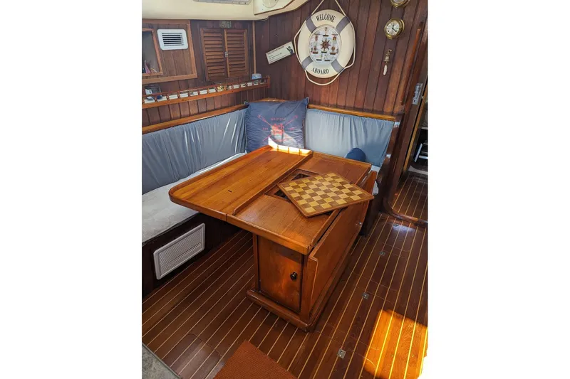 Slide: The Image of Cozy interior of 1990 Bruce Roberts Mauritius Ketch with wooden table and nautical decor. - 5