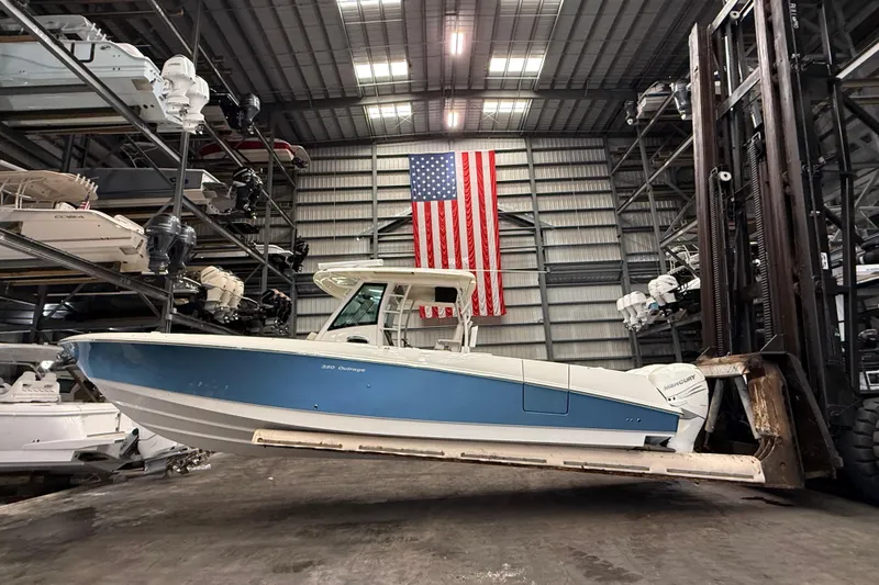 The Image of 2017 Boston Whaler 350 Outrage in warehouse with American flag backdrop. - 0