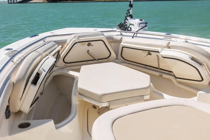 Slide: The Image of 2017 Boston Whaler 350 Outrage boat interior with cushioned seating and storage compartments. - 11