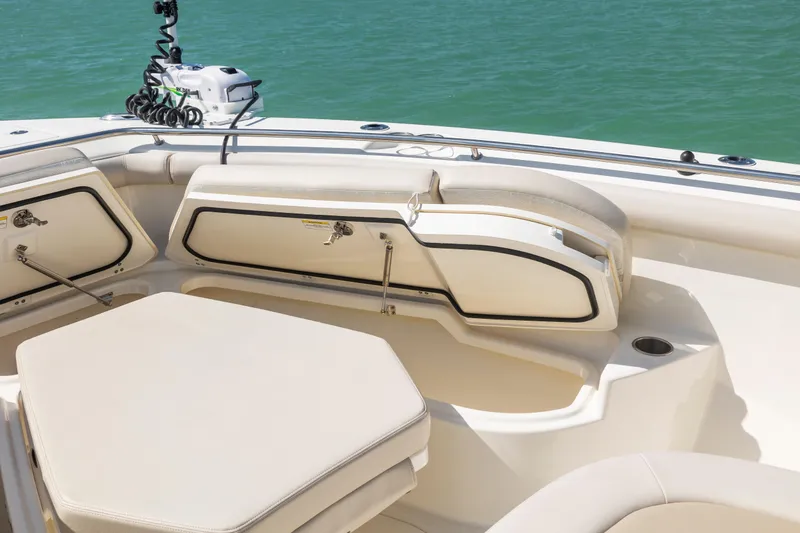 Slide: The Image of 2017 Boston Whaler 350 Outrage boat interior with cushioned seating and storage compartments. - 12