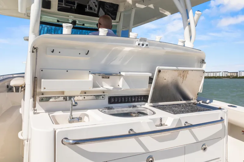 Slide: The Image of 2017 Boston Whaler 350 Outrage boat with open galley, sink, and grill on deck. - 24