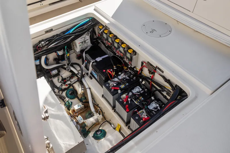Slide: The Image of 2017 Boston Whaler 350 Outrage boat battery compartment with wiring and components. - 28