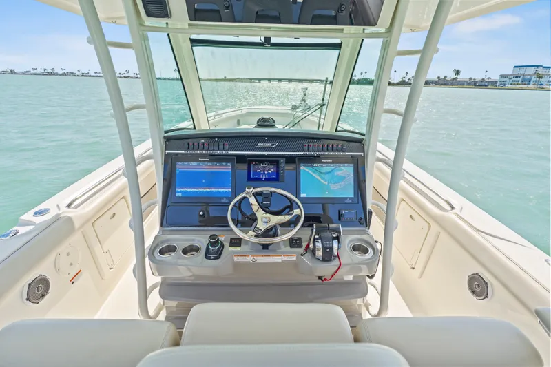 Slide: The Image of 2017 Boston Whaler 350 Outrage helm with advanced navigation displays on calm waters. - 29