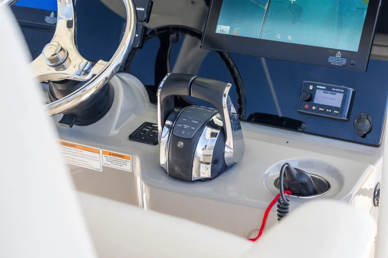 Slide: The Image of 2017 Boston Whaler 350 Outrage helm with steering wheel and electronic controls. - 30