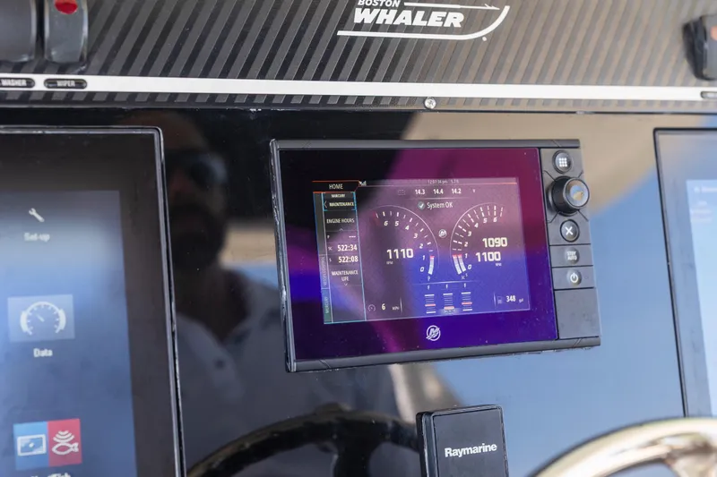 Slide: The Image of Dashboard of a 2017 Boston Whaler 350 Outrage with digital displays and controls. - 33