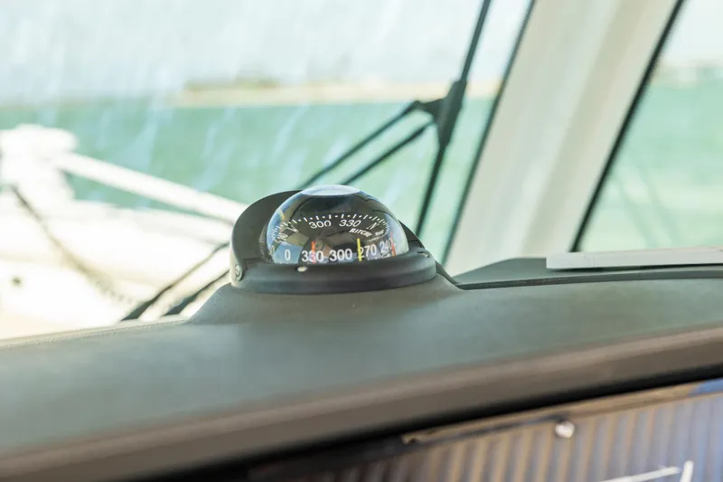 Slide: The Image of Compass on 2017 Boston Whaler 350 Outrage boat dashboard, with ocean view. - 36