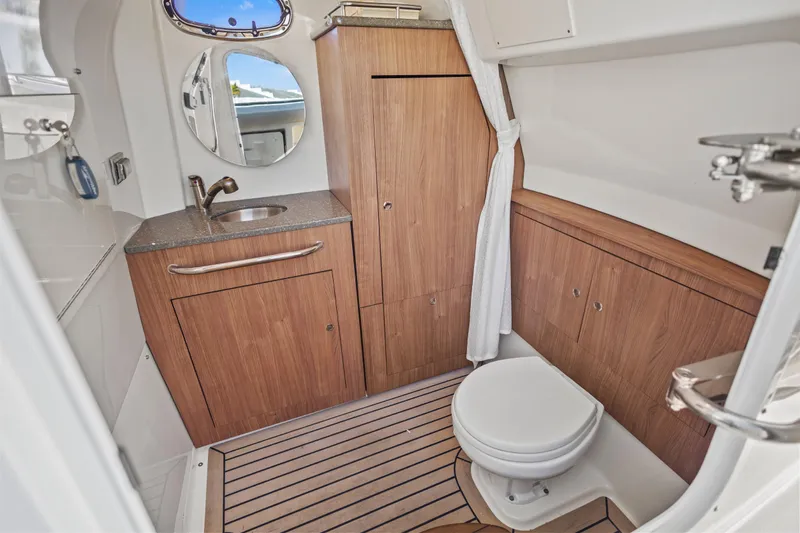 Slide: The Image of Luxurious 2017 Boston Whaler 350 Outrage boat bathroom with wood accents and modern fixtures. - 39