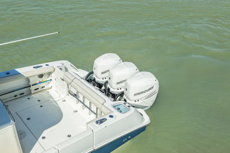 Slide: The Image of 2017 Boston Whaler 350 Outrage with triple Mercury outboard engines on calm water. - 7