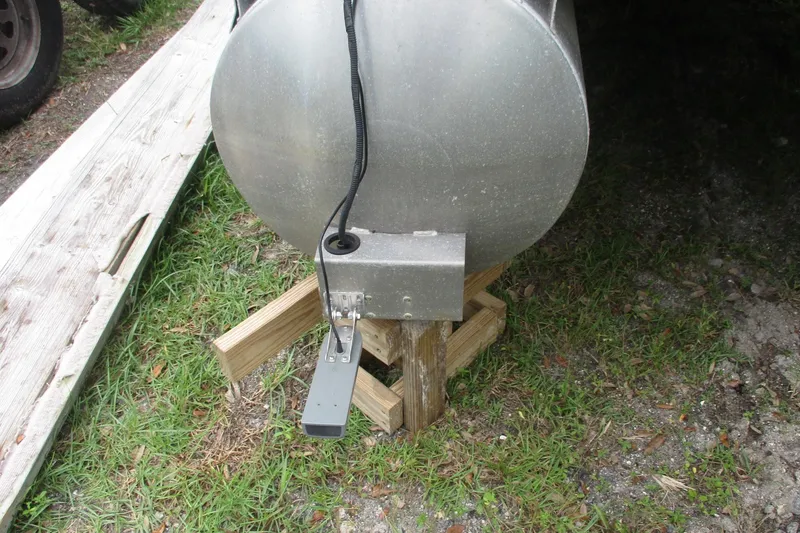 Slide: The Image of 2005 Bennington 21 pontoon boat underside with metal component on wooden support. - 14