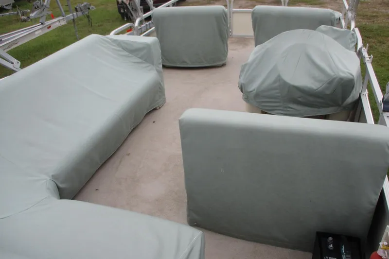 Slide: The Image of 2005 Bennington 21 pontoon boat interior with covered seating and equipment. - 4