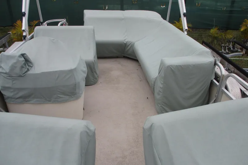 Slide: The Image of 2005 Bennington 21 boat interior with covered seating and equipment. - 5