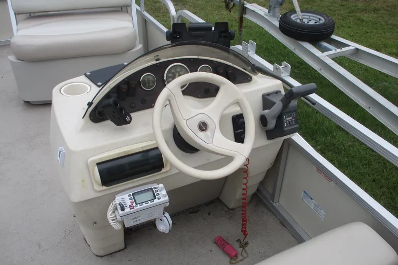 Slide: The Image of 2005 Bennington 21 boat dashboard with steering wheel and control panel. - 9