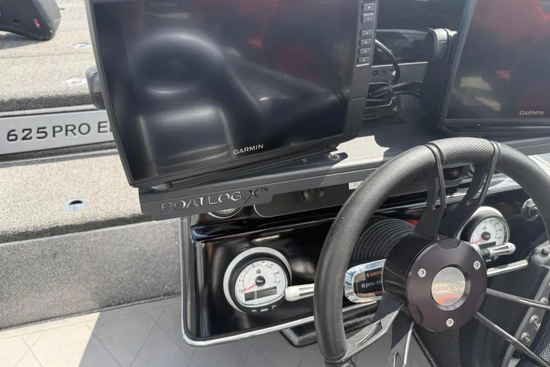 Slide: The Image of Blazer 625 Pro Elite 2020 boat dashboard with Garmin displays and steering wheel. - 14
