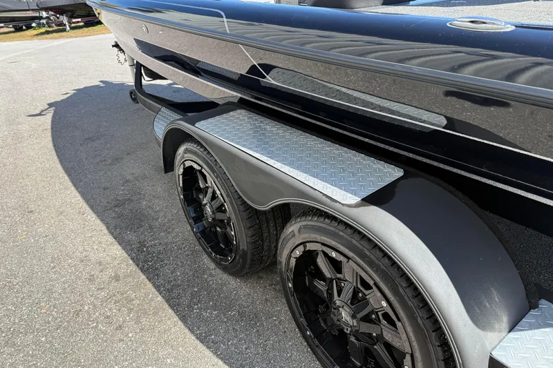Slide: The Image of 2020 Blazer 625 Pro Elite boat trailer with black wheels and diamond plate steps. - 2