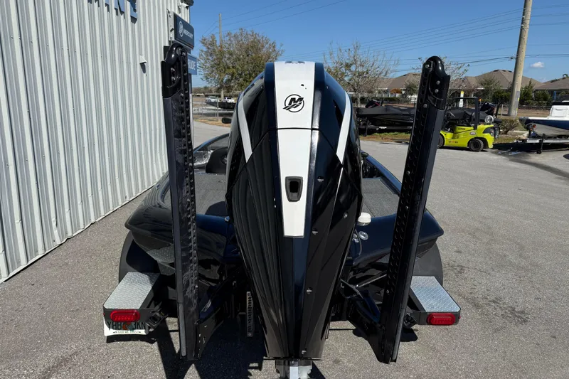 Slide: The Image of 2020 Blazer 625 Pro Elite boat with powerful outboard motor in a parking lot. - 4