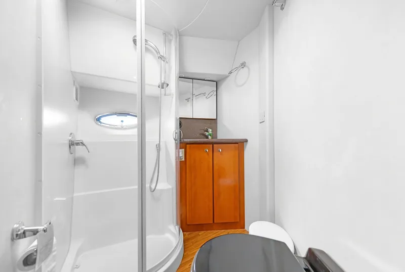 Slide: The Image of Bathroom in 2007 Silverton 45 Convertible with shower and wooden cabinet. - 20