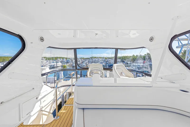 Slide: The Image of Interior of a 2007 Silverton 45 Convertible yacht overlooking the marina. - 25