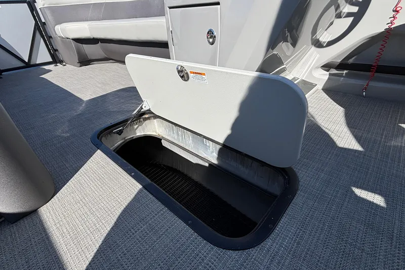 Slide: The Image of Open storage compartment on 2026 Viaggio X24U boat, featuring gray interior and seating. - 12
