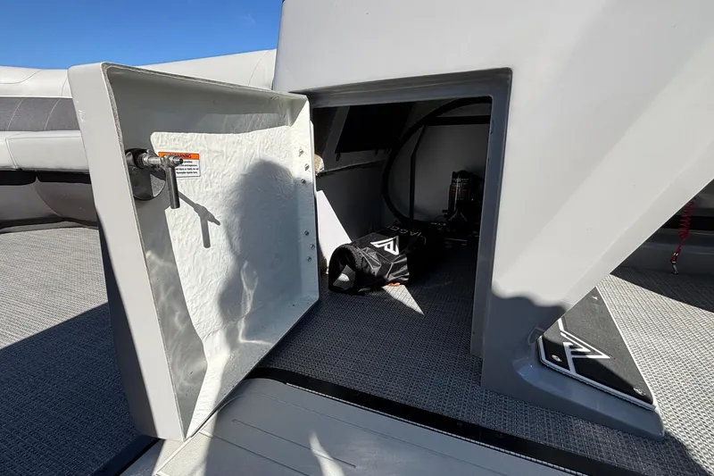 Slide: The Image of Open storage compartment on 2026 Viaggio X24U boat, featuring interior equipment and accessories. - 13