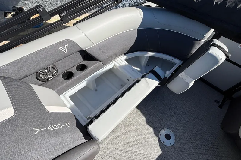 Slide: The Image of 2026 Viaggio X24U boat interior with open storage compartment and cup holders. - 17