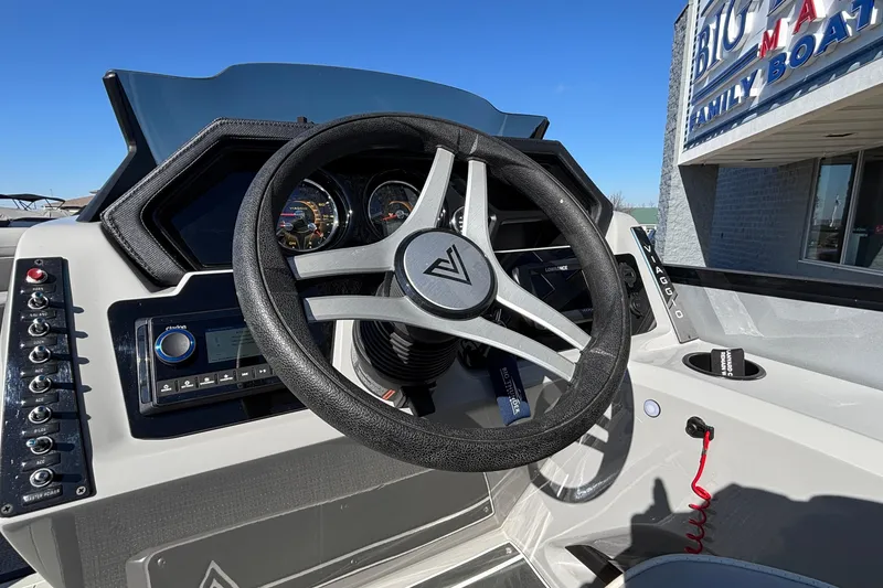 Slide: The Image of Steering wheel of 2026 Viaggio X24U boat at dealership, showcasing dashboard controls. - 7