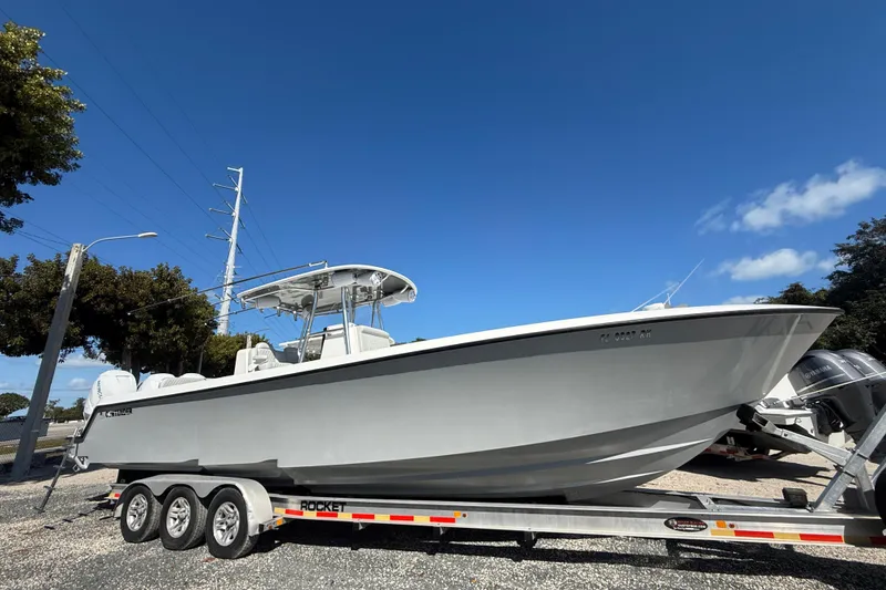 The Image of 2016 Contender 35 ST boat on trailer under clear blue sky. - 0