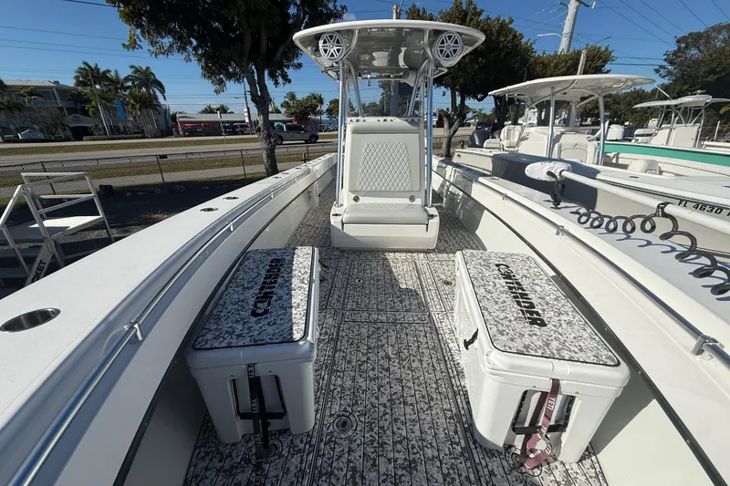 Slide: The Image of 2016 Contender 35 ST boat interior with seating and storage, docked under clear skies. - 10
