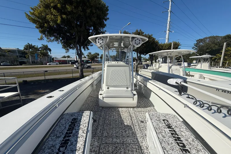 Slide: The Image of 2016 Contender 35 ST boat with center console, docked under clear skies. - 11