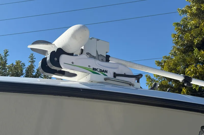 Slide: The Image of Rhodan trolling motor mounted on a 2016 Contender 35 ST boat under clear blue sky. - 21