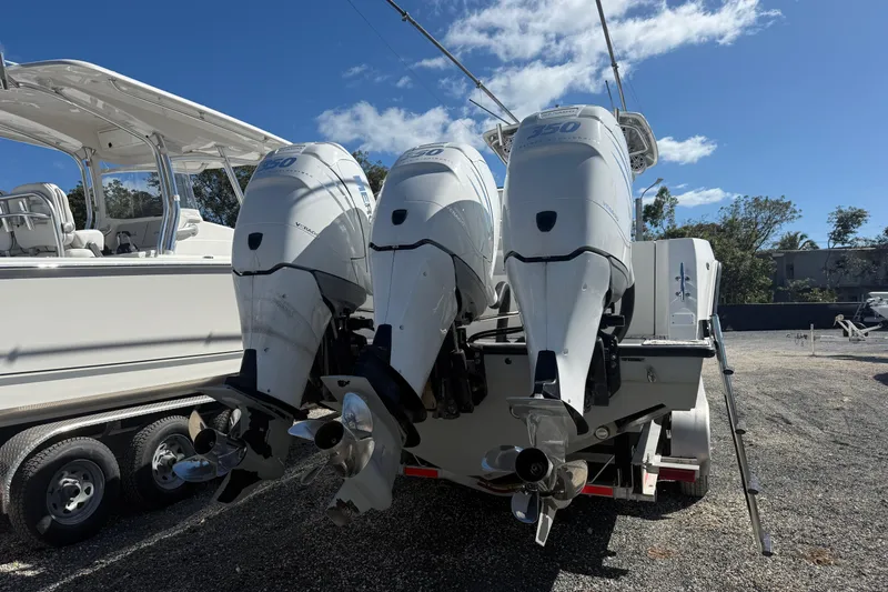 Slide: The Image of 2016 Contender 35 ST boat with triple outboard engines on a trailer. - 23