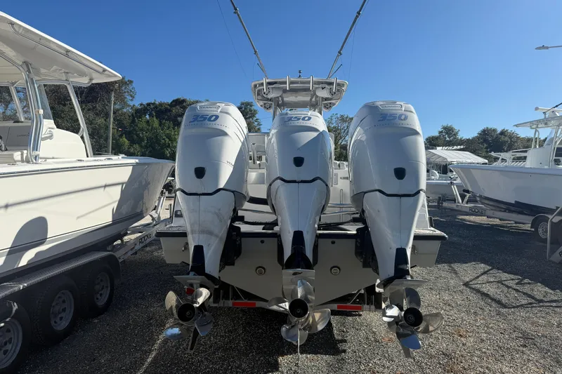 Slide: The Image of 2016 Contender 35 ST boat with triple 350 horsepower engines, docked outdoors. - 3