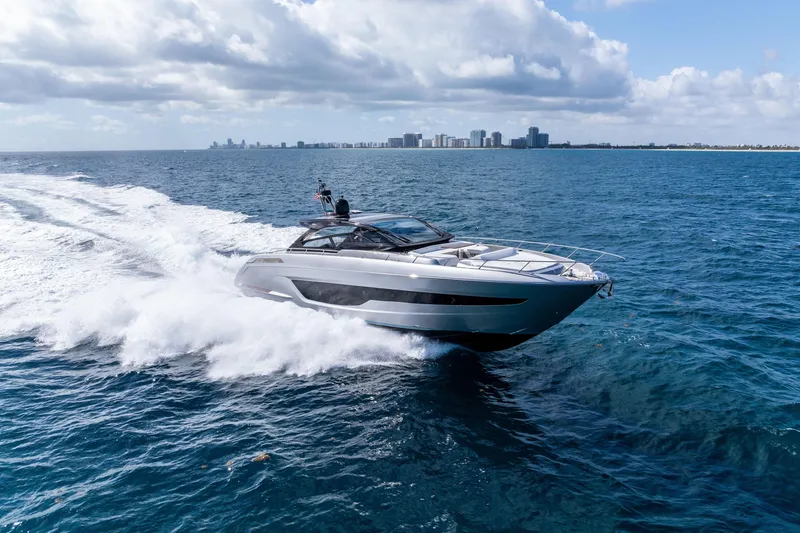 Slide: The Image of 2023 Riva 68 Diable luxury yacht cruising on open sea under cloudy sky. - 1