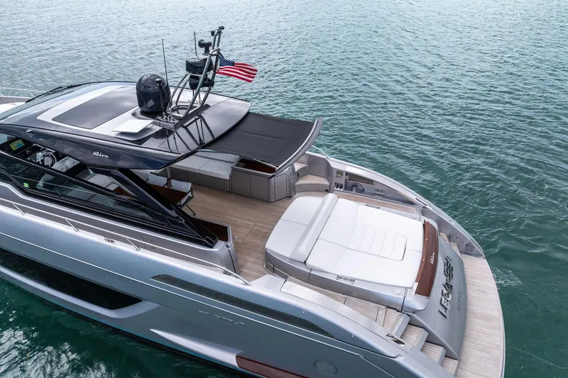 Slide: The Image of Luxurious 2023 Riva 68 Diable yacht on serene water, showcasing sleek design and spacious deck. - 10