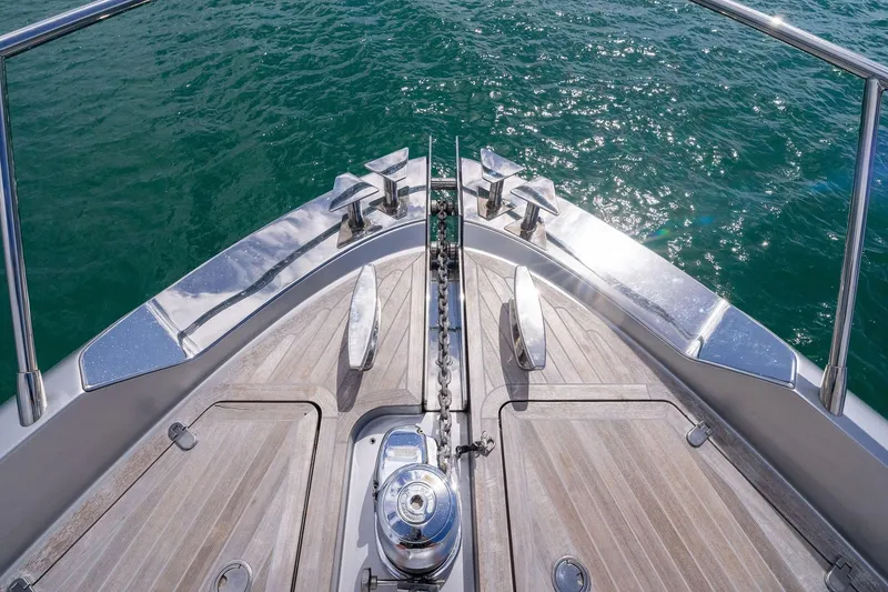 Slide: The Image of Bow of 2023 Riva 68 Diable yacht with polished deck and ocean view. - 12