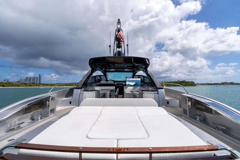 Slide: The Image of Luxurious 2023 Riva 68 Diable yacht on serene waters under a partly cloudy sky. - 16